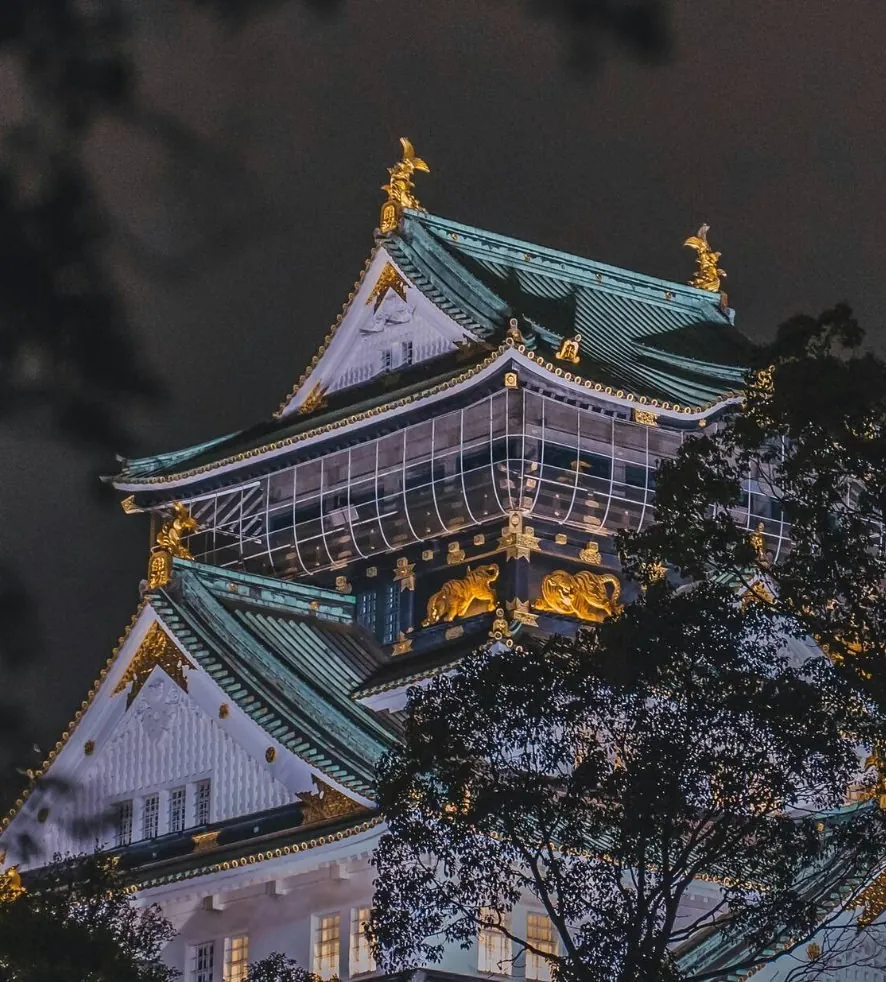 Osaka Castle's keep seen through branches — a haiku-style composition